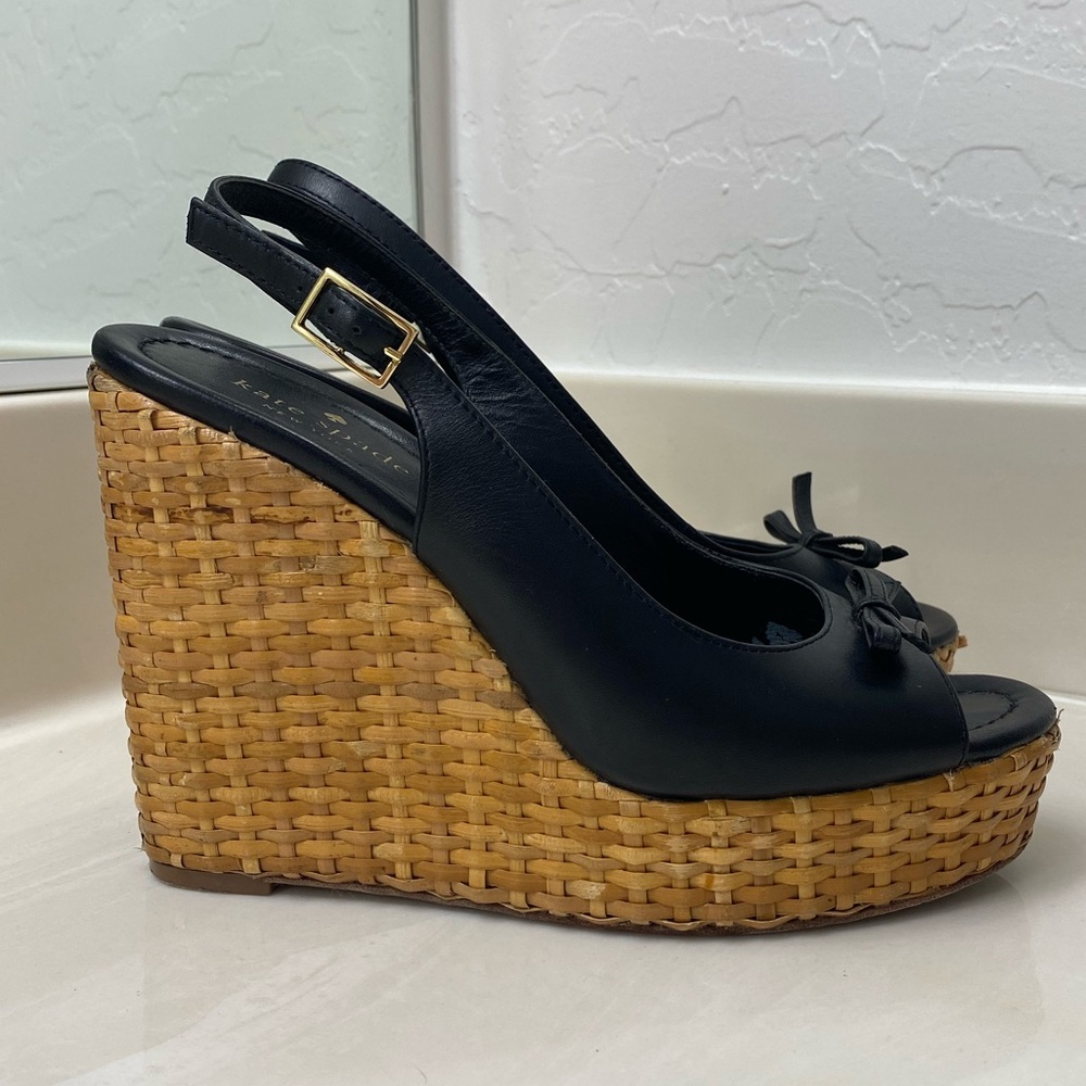 Black Kate Spade wedges with a wicker heel